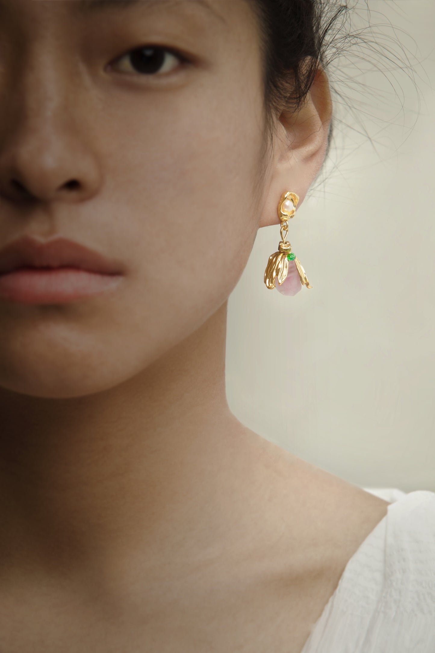 Lifestyle shot of the Amethyst Pearl Golden Flower Dangle Earrings worn, adding a touch of elegance with amethyst and pearls for a refined look