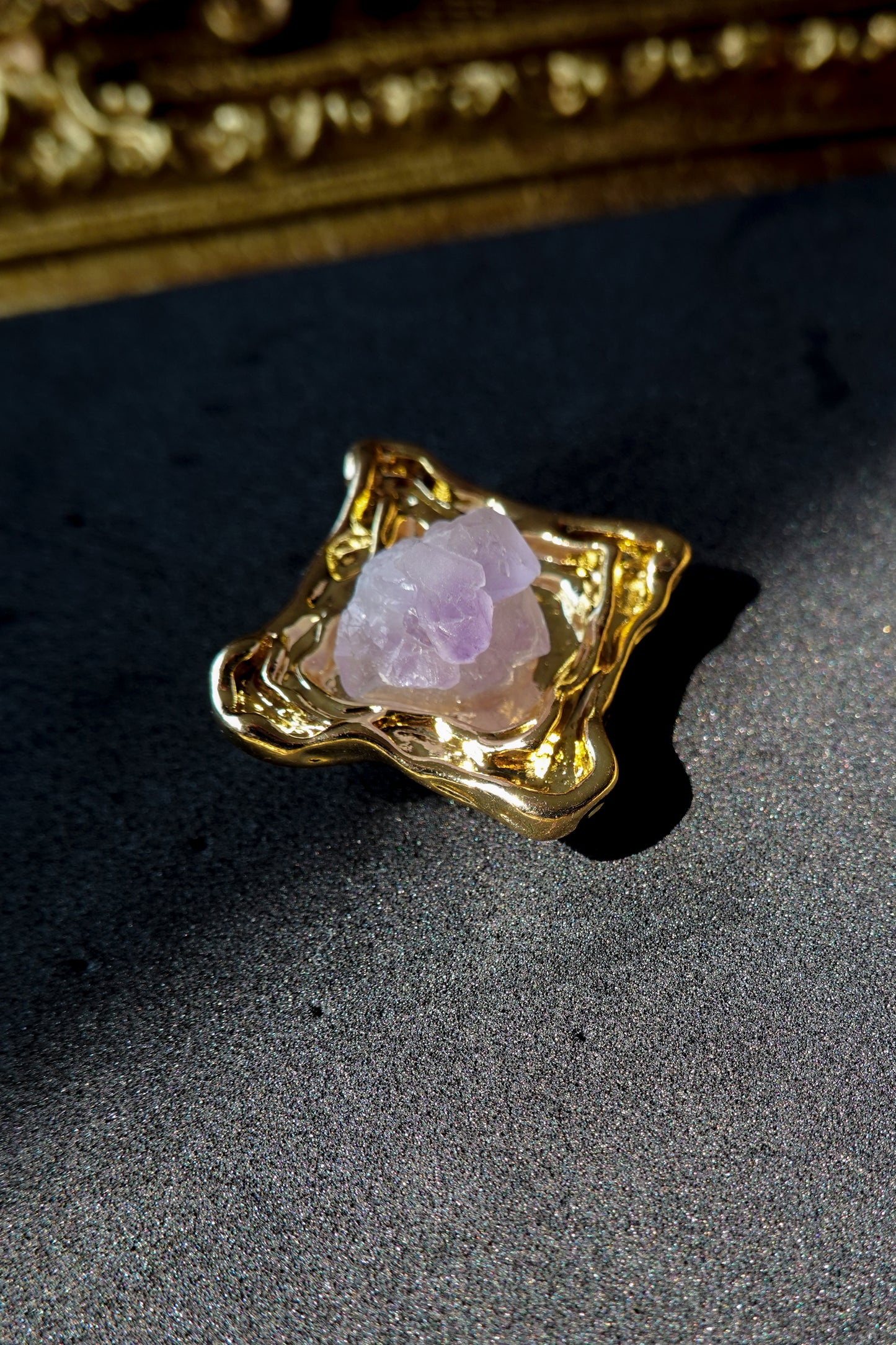 Close-up of the Amethyst Square Golden Stud Earrings, focusing on the sharp cut of the amethyst stones and fine gold setting