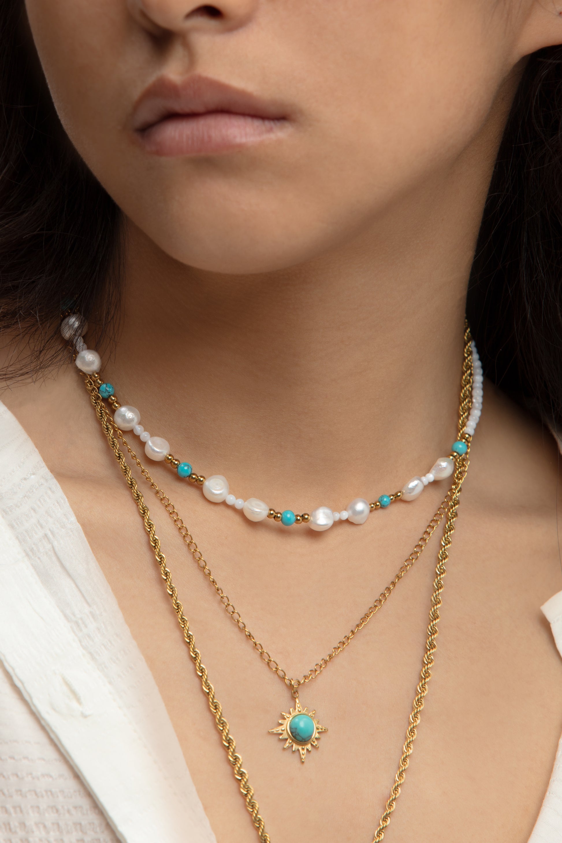 Lifestyle shot of the Blue Turquoise Pearl Layered Necklace worn, perfect for adding a refreshing pop of color with a bohemian vibe