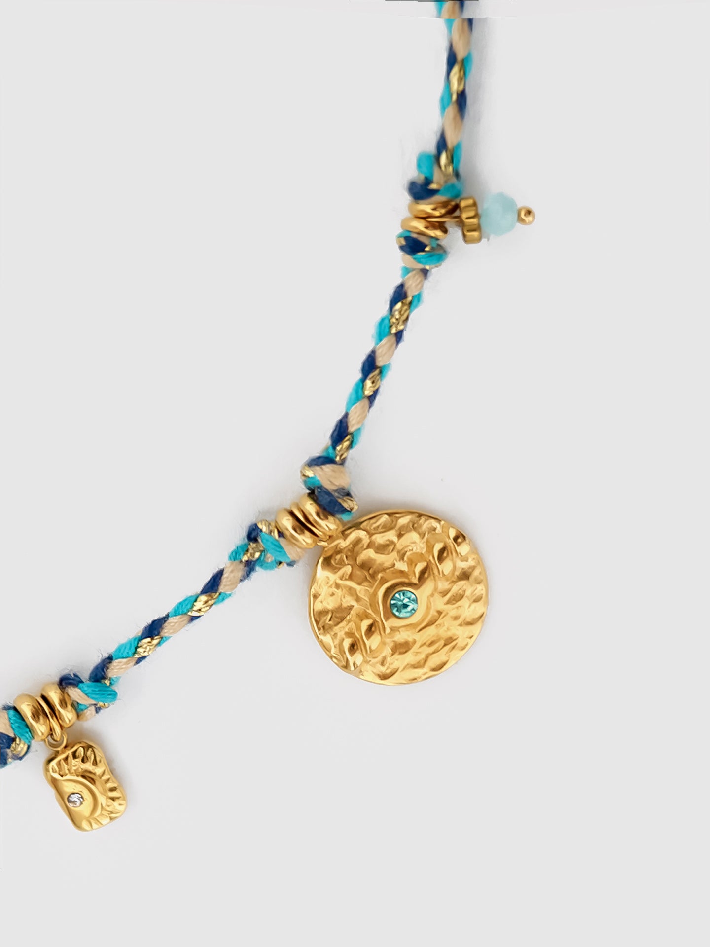 Close-up of the Cotton Rope Gold Wire Braided Vintage Sun Necklace, capturing the braided cotton rope and the golden sun charm with fine detailing