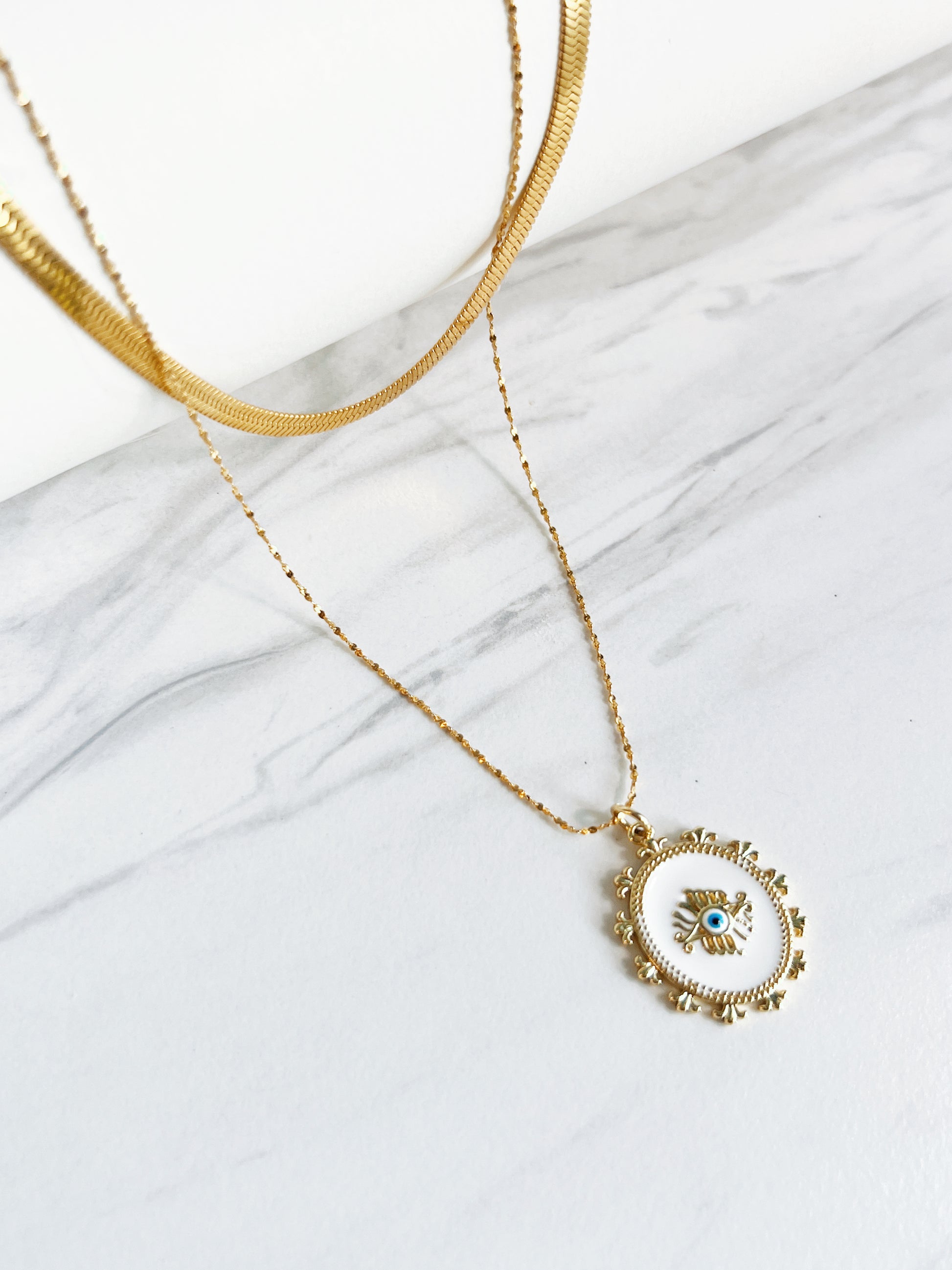 Beautifully crafted layered golden necklace with spiritual symbols for a harmonious balance of elegance and energy