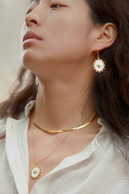 Stunning layered golden necklace adorned with spiritual symbols, perfect for adding depth to your spiritual style