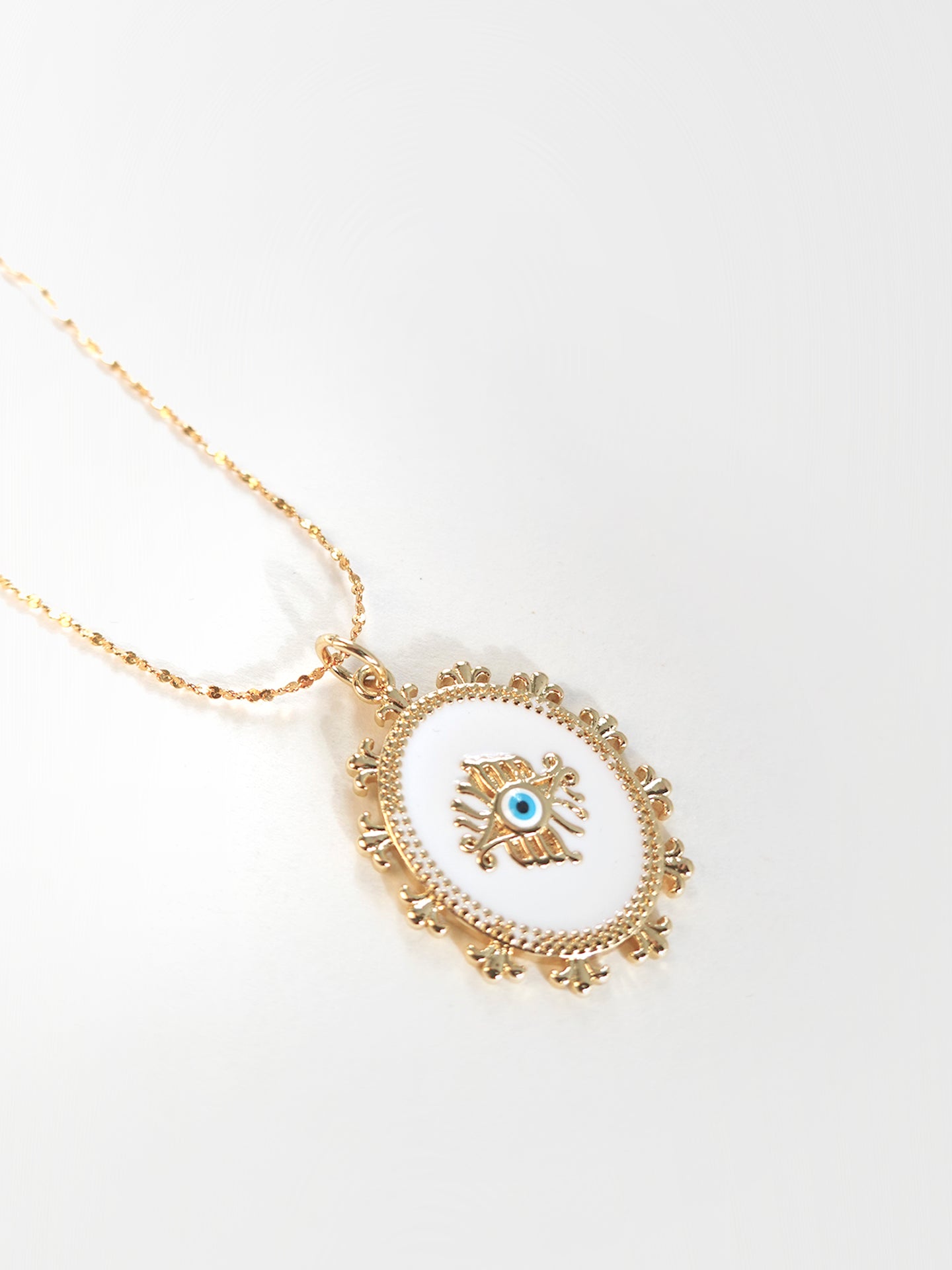 Closeup of layered golden necklace with intricate spiritual symbols for a meaningful, stylish look